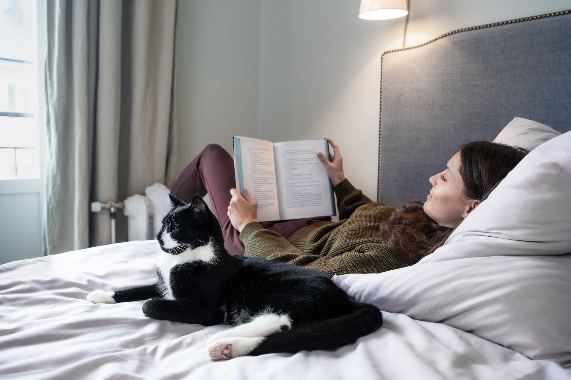 Woman and a cat on a bed